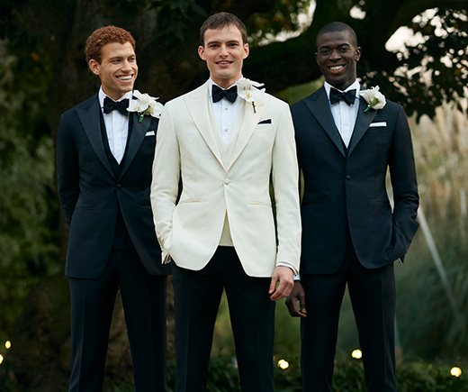 Rubensteins New Orleans - Style Sessions sideline photo. Groom and male wedding party in tuxedos.